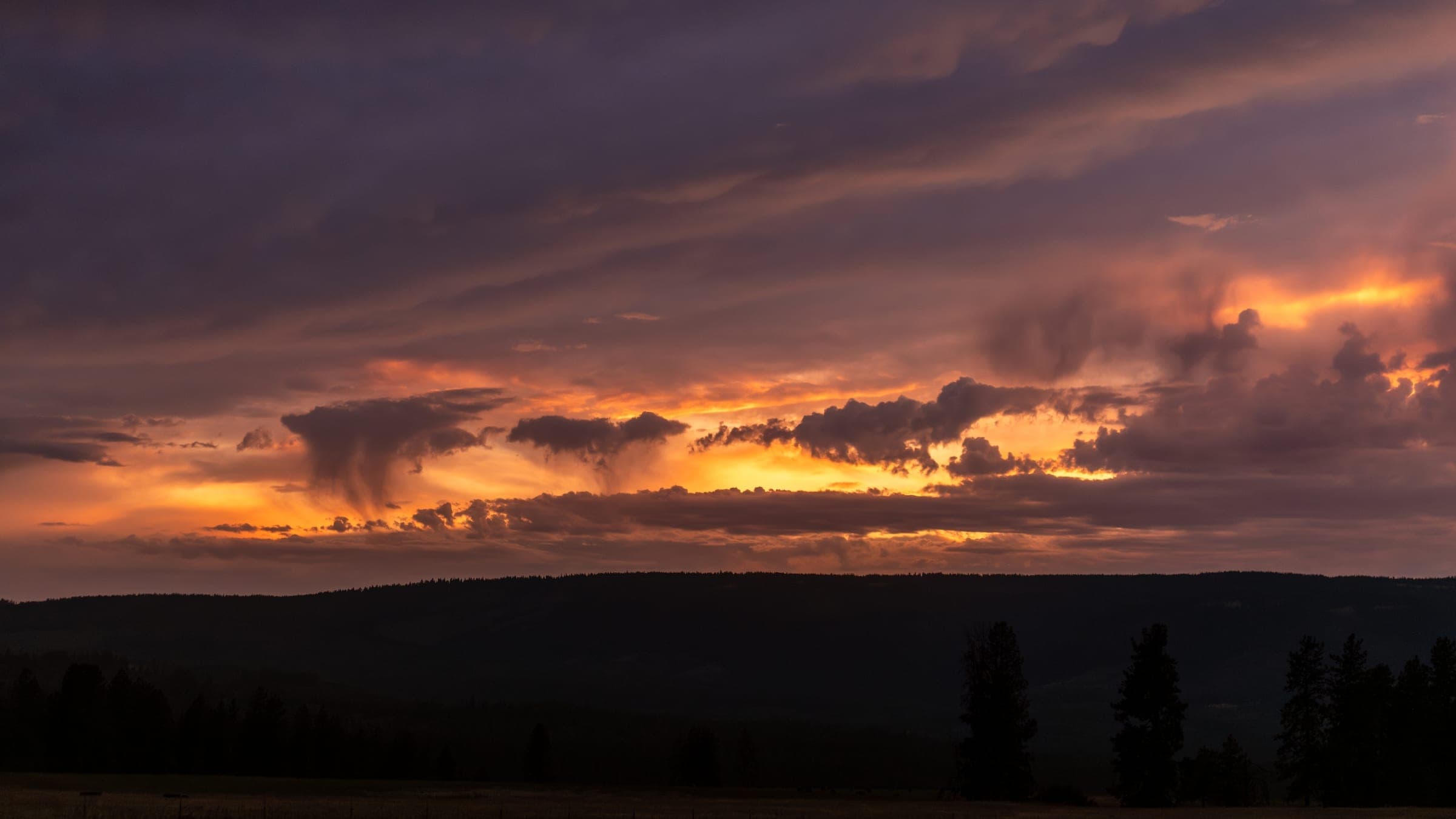 Warm sunset colors stretching across the farmland
