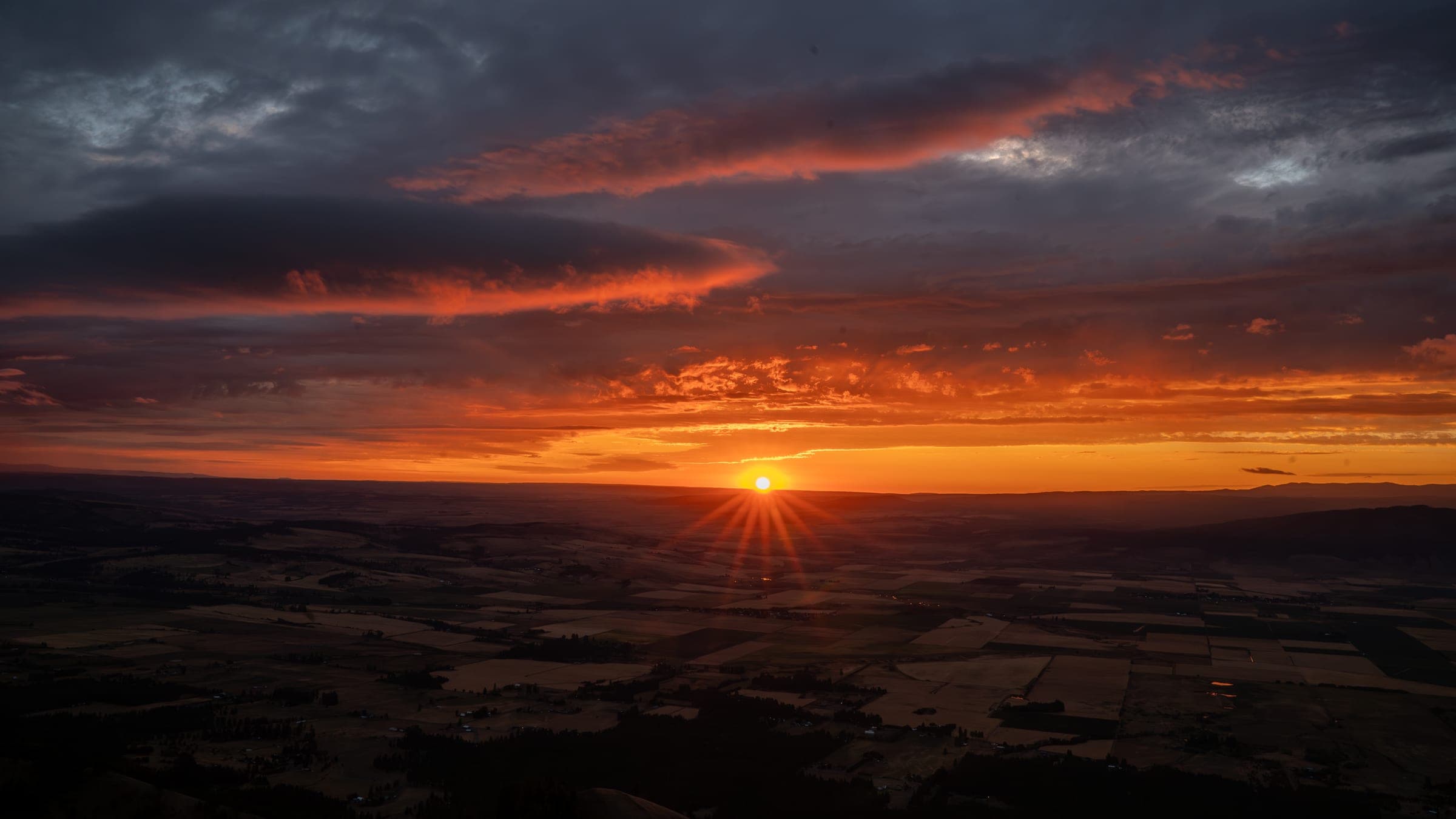 Sun rays piercing through clouds above Indian Rock